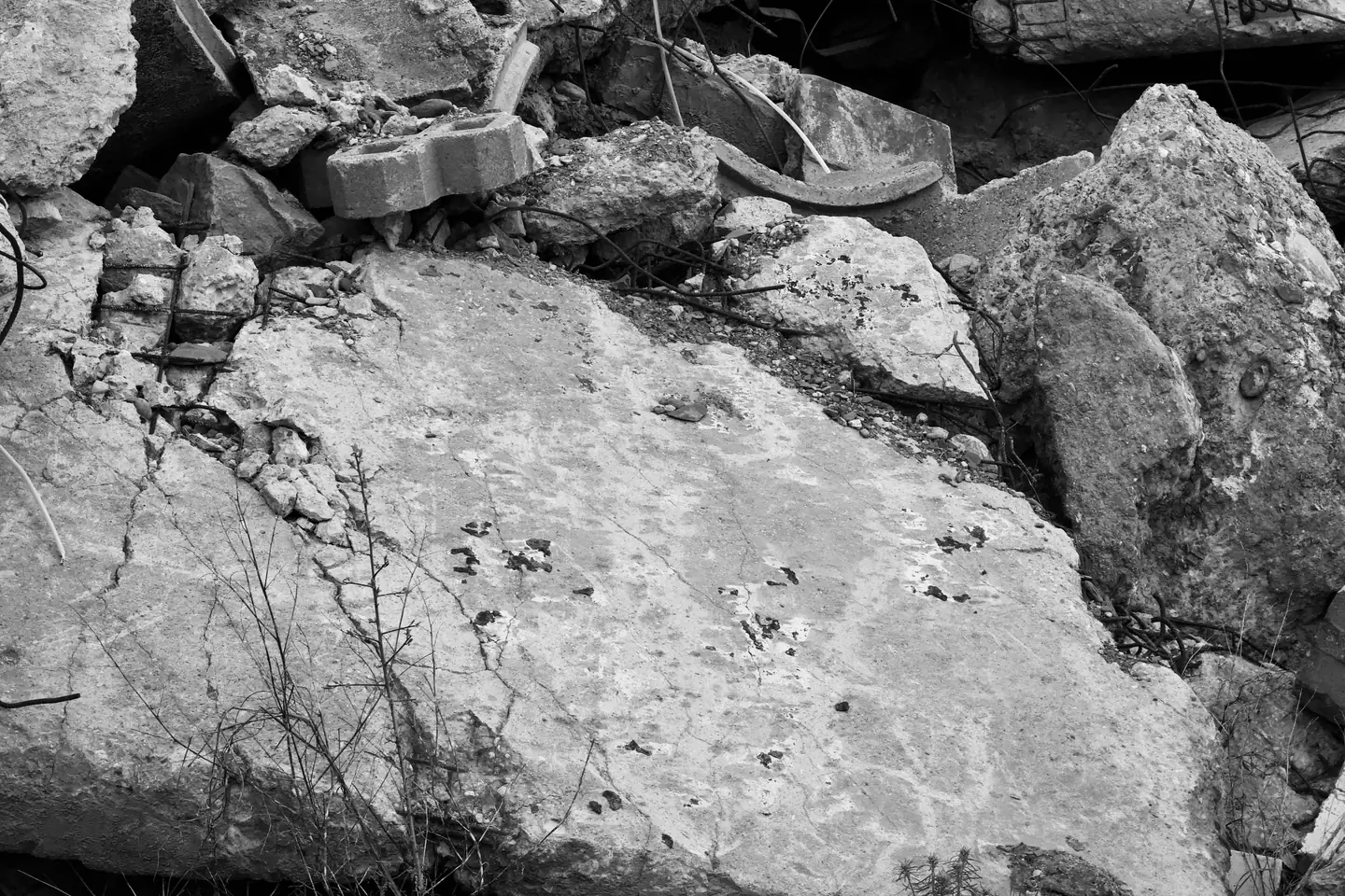 Broken concrete slabs stacked for removal after demolition